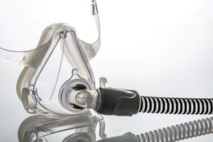 Close-up of CPAP mask sitting on reflective surface